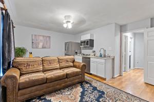 a living room with a couch and a kitchen at Apartment with garage parking Patio close IAD in Sterling