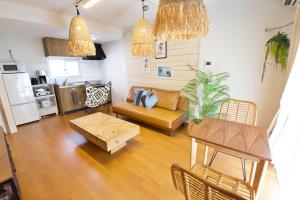 a living room with a couch and a table at クラリス大川 A号室 in Ishigaki Island
