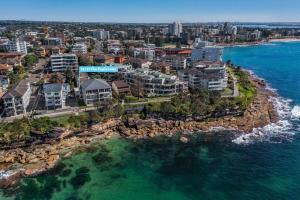 an aerial view of a city and the ocean at On The Esplanade - Close to beach & Cronulla mall with Aircon in Cronulla