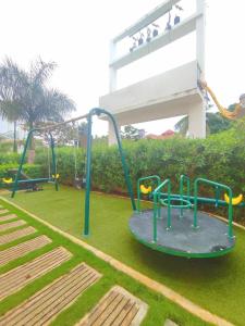 a park with a playground with a slide at Palawan Paradise Condotel 7F in Puerto Princesa City