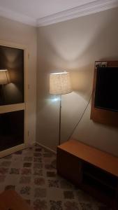 a lamp in a corner of a room with a window at شقق فندقية التلال in Makkah