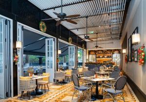 a restaurant with tables and chairs and a ceiling at Hotel Indigo Shenzhen Overseas Chinese Town, an IHG Hotel in Shenzhen