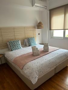 a bedroom with a large bed with pillows on it at Jelinas bright apartment in the centre of Nafplio in Nafplio