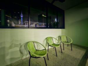 three green chairs in a room with a window at Stay429 at Bukit Bintang 4bedroom 15pax By Shine Stay in Kuala Lumpur +21 photos