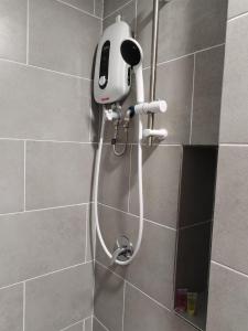 a shower with a hair dryer in a bathroom at SRITEL BOUTIQUE HOTEL in Shah Alam