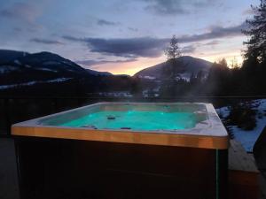 a jacuzzi tub with a view of the mountains at Five Star-Amazing views and Hot Tub in Crescent Valley