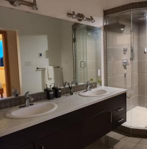 a bathroom with two sinks and a shower at Five Star-Amazing views and Hot Tub in Crescent Valley