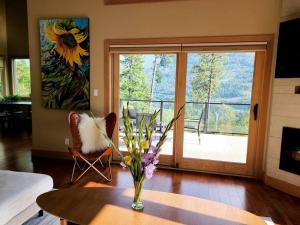a living room with a vase of flowers on a table at Five Star-Amazing views and Hot Tub in Crescent Valley