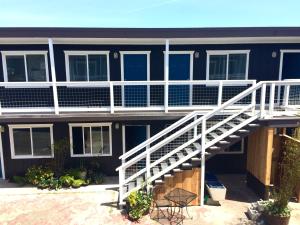 a house with a white staircase in front of it at Salt Hotel in Ilwaco