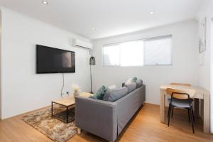 a living room with a couch and a table at Suburban Living - 2 bedroom apartment Victoria Park in Perth