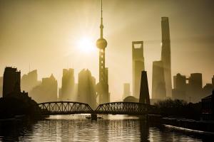 a misty city with a bridge and the shanghai tower at Shanghai Atour Hotel On The Bund- People Square in Shanghai +44 photos