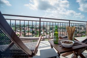 a balcony with a table and two bottles of beer at The Aviator Apartment - Jacuzzi & Panoramic View in Cluj-Napoca