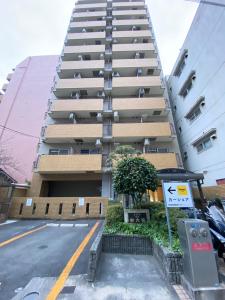 a tall building with a parking meter in front of it at A&C STAY Shin-Osaka Higashikuchi 83 in Osaka