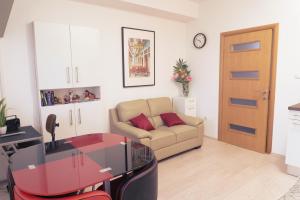 a living room with a couch and a table at Apartmani Jastreb in Jastrebarsko