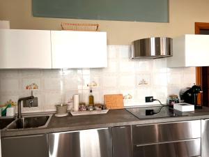 a kitchen with a sink and a counter top at Appartamento in centro storico "La Casa di Cri" in Asti