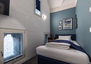 ein kleines Schlafzimmer mit einem Bett und einem Fenster in der Unterkunft Ambrosia Hüsli in Rheinfelden