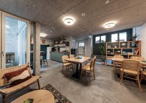 a living room with a table and chairs at Ambrosia Hüsli in Rheinfelden