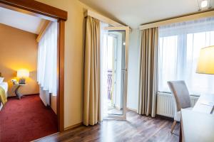 Postel nebo postele na pokoji v ubytování Hotel Landskron