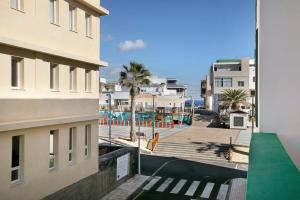 a view of the pool from the balcony of a building at Apartamento Kalma in Las Eras