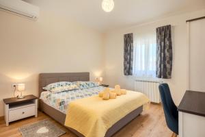 a bedroom with a bed with two teddy bears on it at VILLA ISTRA in Kaštelir +31 photos