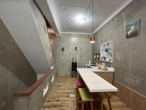 a kitchen with a white counter and a sink at You Ai Heya Homestay in Tainan