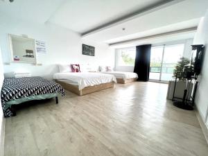 a large living room with two beds and a couch at Nanwan 166 in Nanwan