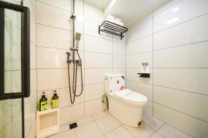 a bathroom with a toilet and a shower at 2 Old Town Designer Chalet 200 year old house in Shanghai