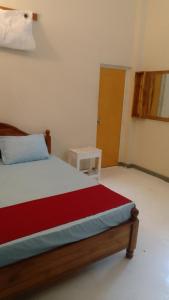 a bedroom with a bed and a table in a room at Serene villa in Galle