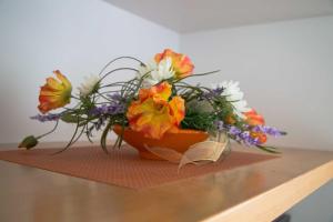 a bouquet of flowers sitting on top of a table at Kapitaensweg 17 in Ostseebad Karlshagen