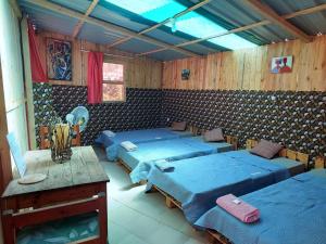 a room with four blue beds in a room at Keur Malaka in Dakar