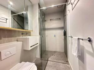 a bathroom with a glass shower and a sink at Avant CBD Cozy & Spacious 2BR Residences in Melbourne