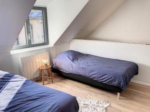 sypialnia na poddaszu z 2 łóżkami i stołem w obiekcie La Luchonnaise-Maison hypercentre w mieście Luchon