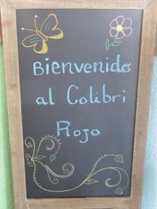 a chalkboard with a picture of a cow on it at Hotel El Colibri Rojo - Cabinas - Le Colibri Rouge in Cahuita