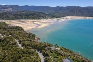 an aerial view of a beach and the ocean at Tokongawa Retreat in Kaiteriteri