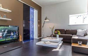 a living room with a couch and a flat screen tv at Lotsenstieg 05 in Ostseebad Karlshagen
