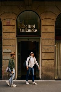 a woman standing in front of a building at TOC Hotel Las Ramblas in Barcelona