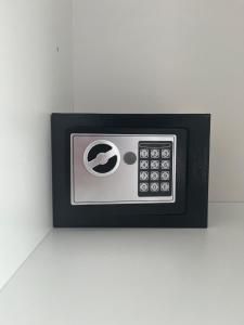 a microwave oven on a white wall at BlueLine apartment 2 in Loutraki