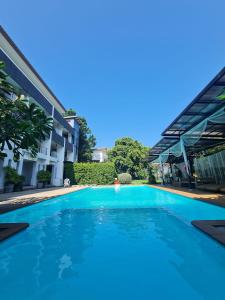 a swimming pool in front of a building at Bualinn Resort in Nong Khai