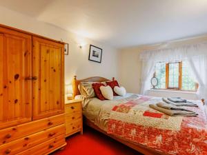 1 dormitorio con 1 cama, vestidor y ventana en 4 Bed in Dartmoor National Park 49535 en Sampford Courtenay