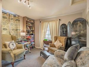 a living room with a couch and two chairs at 5 Bed in Swaffham 59799 