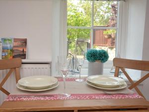 a table with plates and wine glasses on it at 1 bed in Pwllheli 60173 in Pwllheli