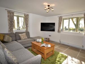 a living room with a couch and a table at 3 bed property in Winkleigh 66041 in Winkleigh