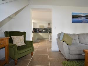 a living room with a couch and a chair at 3 bed property in Winkleigh 66041 in Winkleigh