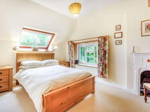 a bedroom with a large bed and a fireplace at 4 bed in Bowcombe IC017 in Bowcombe