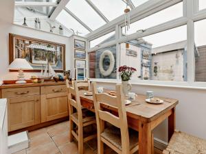 a dining room with a table and chairs and a window at 3 bed property in Brixham BX017 in Brixham
