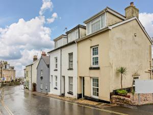 a row of houses on a rainy street at 3 bed property in Brixham BX017 in Brixham
