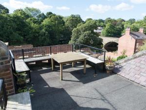 a picnic table and benches on a roof at 4 bed property in Knaresborough HH090 in Knaresborough