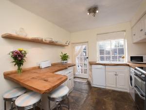 a kitchen with white cabinets and a wooden counter top at 4 bed property in Knaresborough HH090 in Knaresborough