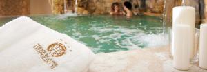 a group of people in a swimming pool with candles at Hotel Terme Marine Leopoldo II TERME & SPA in Marina di Grosseto