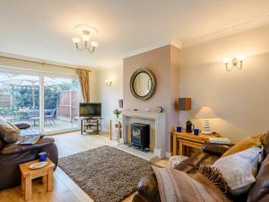 ein Wohnzimmer mit einem Sofa und einem Kamin in der Unterkunft 3 bed property in Weybourne Norfolk KT069 in Weybourne